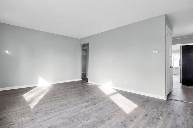 unfurnished room with wood-type flooring