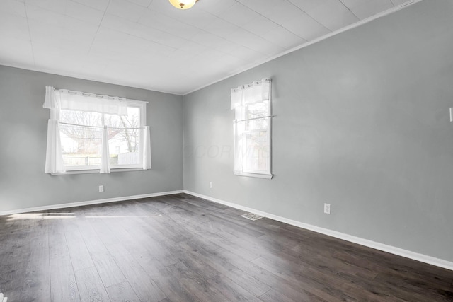 spare room with dark hardwood / wood-style floors