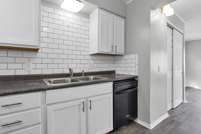 kitchen with white cabinets, decorative backsplash, sink, and black dishwasher