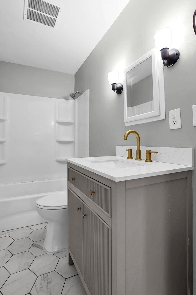 full bathroom with vanity, washtub / shower combination, and toilet