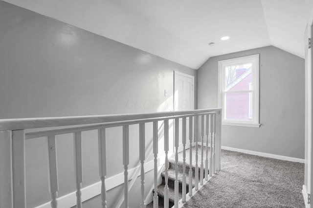 hall featuring carpet floors and vaulted ceiling