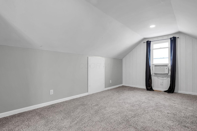 additional living space with lofted ceiling, carpet floors, and cooling unit