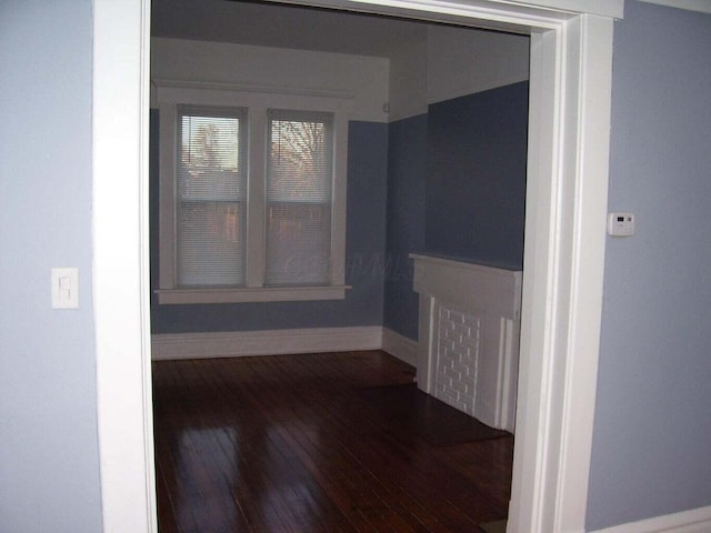 interior space featuring baseboards and hardwood / wood-style floors