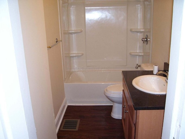 full bath with vanity, wood finished floors, visible vents, bathing tub / shower combination, and toilet