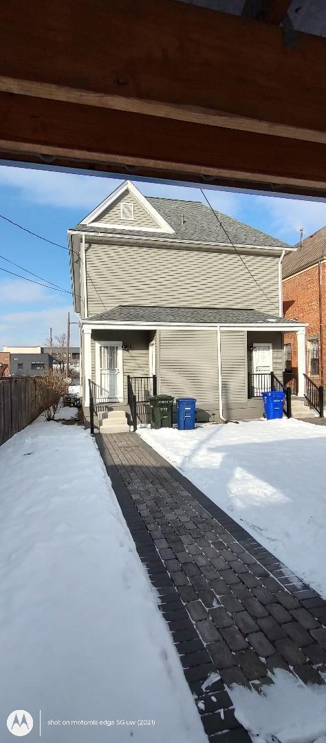 snow covered patio featuring fence