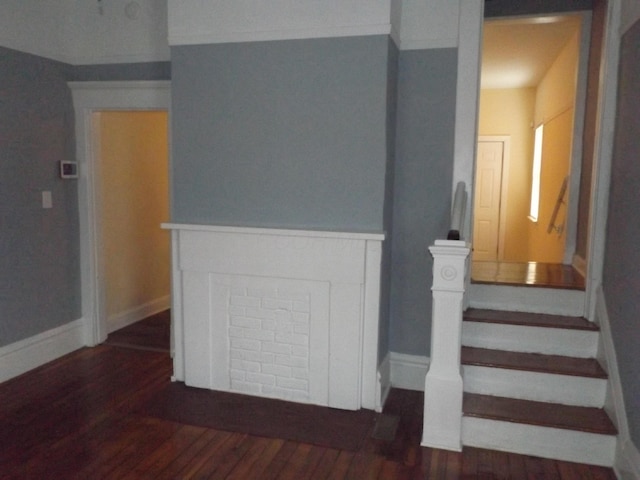 staircase with wood finished floors and baseboards