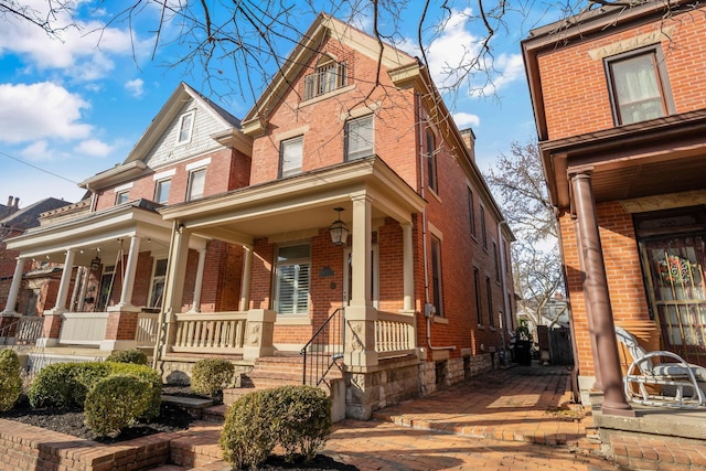 view of front of property with covered porch and brick siding