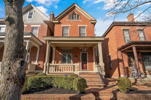 view of front of property featuring covered porch and brick siding