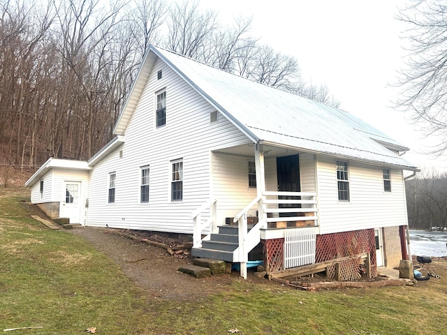 back of property featuring a lawn