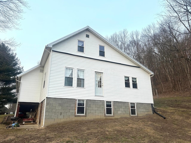 view of property exterior with a lawn