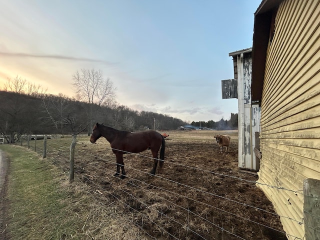 view of stable featuring a rural view