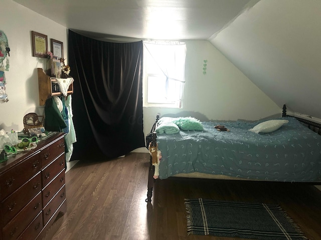 bedroom featuring vaulted ceiling and hardwood / wood-style floors