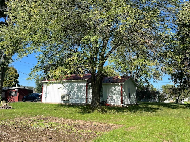 view of side of property with a yard