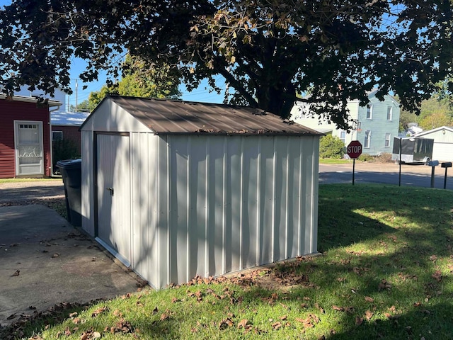 view of outbuilding with a lawn