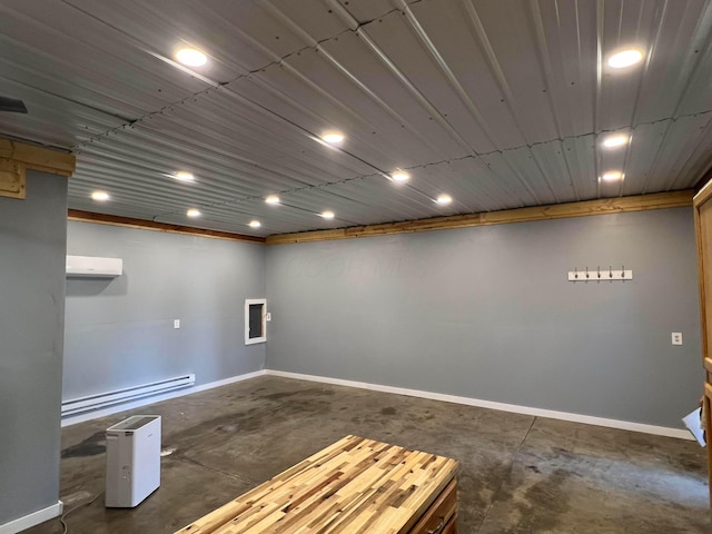 basement featuring a baseboard radiator and a wall unit AC