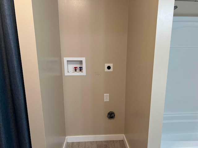 washroom with electric dryer hookup, washer hookup, and hardwood / wood-style flooring