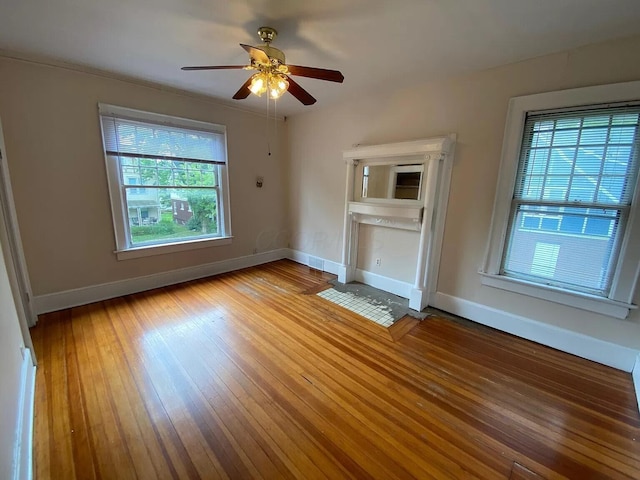 unfurnished living room featuring ceiling fan and hardwood / wood-style floors