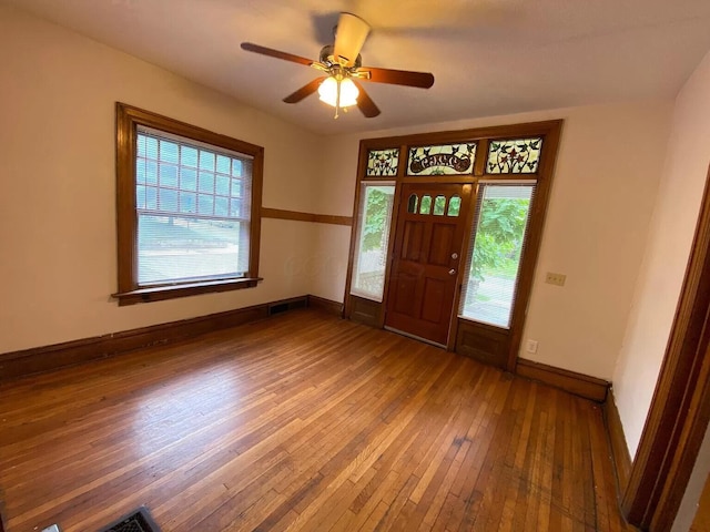 foyer entrance with hardwood / wood-style flooring and ceiling fan