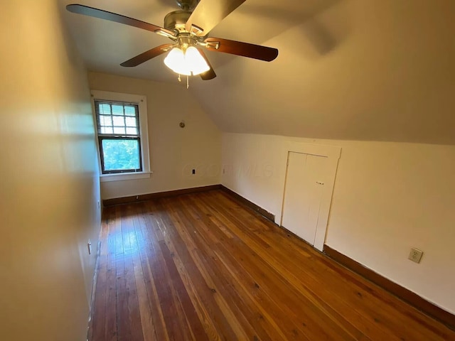 additional living space featuring ceiling fan, dark hardwood / wood-style floors, and vaulted ceiling