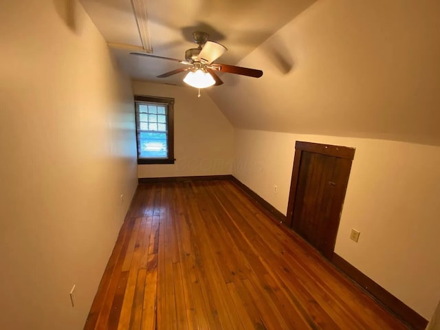 bonus room featuring dark wood-type flooring, ceiling fan, and vaulted ceiling