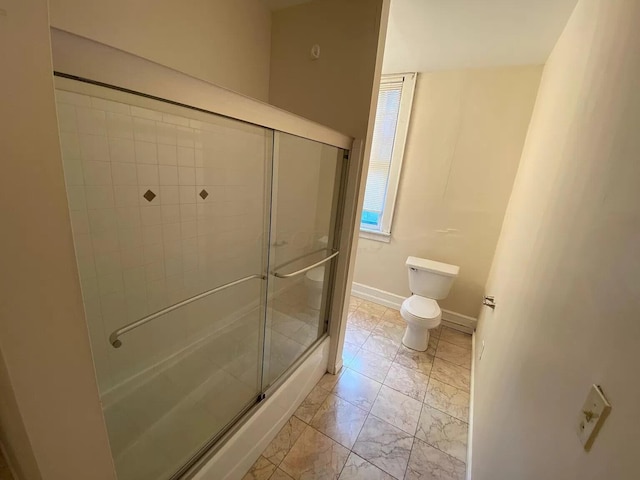 bathroom featuring toilet and an enclosed shower