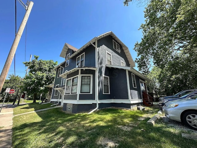 view of side of home featuring a yard