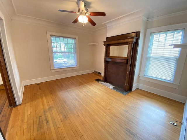 unfurnished living room featuring light hardwood / wood-style flooring, ornamental molding, and ceiling fan