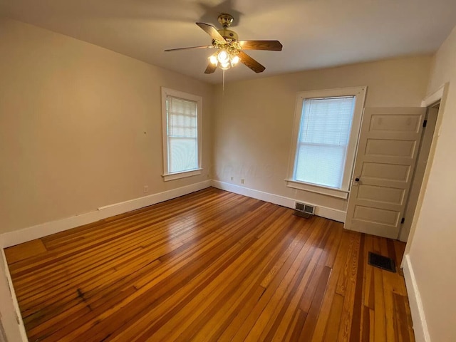 empty room with wood-type flooring and ceiling fan