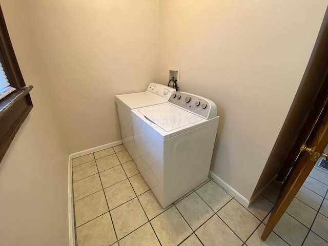 laundry area featuring independent washer and dryer and light tile patterned floors