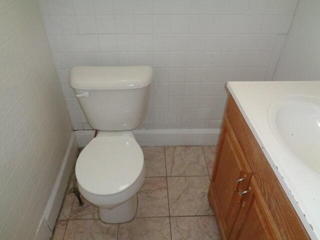 bathroom with vanity, toilet, and tile patterned flooring