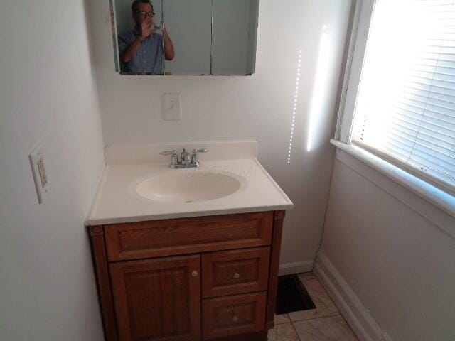 bathroom featuring tile patterned flooring and vanity