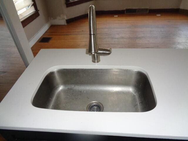 room details with wood-type flooring and sink