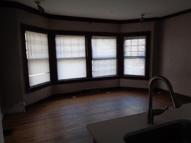 dining area with dark hardwood / wood-style floors and sink