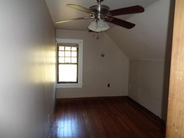 bonus room featuring dark wood-type flooring, vaulted ceiling, and ceiling fan