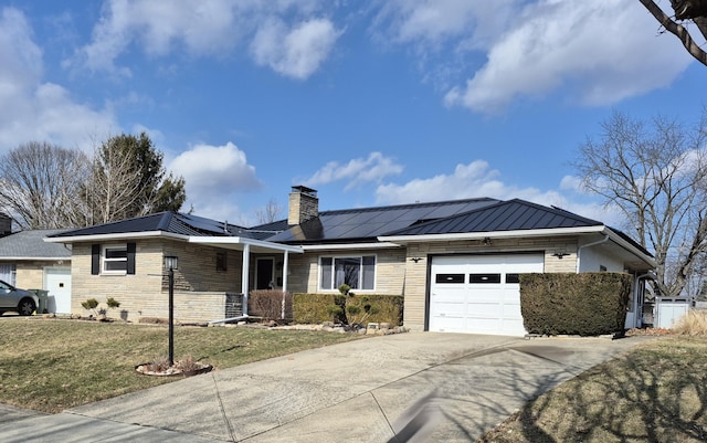 ranch-style house with a chimney, a standing seam roof, metal roof, a garage, and stone siding