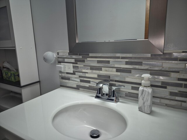 details featuring tasteful backsplash and a sink