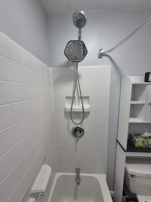 bathroom featuring  shower combination and toilet