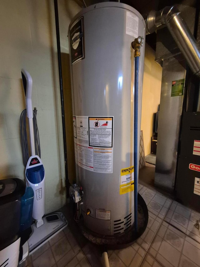 utility room featuring gas water heater and heating unit