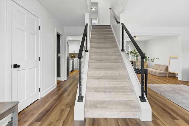 staircase with wood finished floors