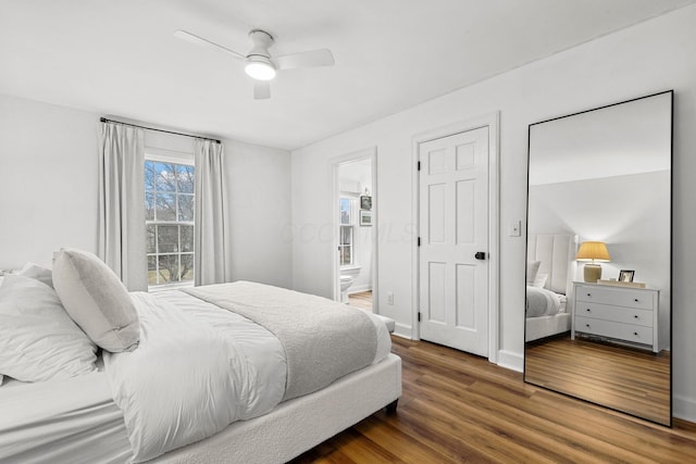 bedroom featuring ensuite bathroom, ceiling fan, baseboards, and wood finished floors