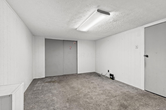 spare room featuring a textured ceiling and carpet floors