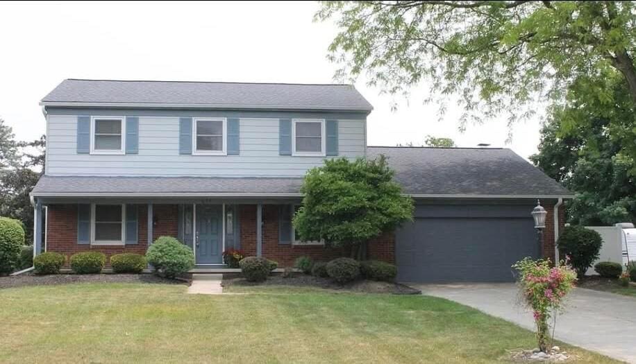 view of front of property with a garage and a front lawn