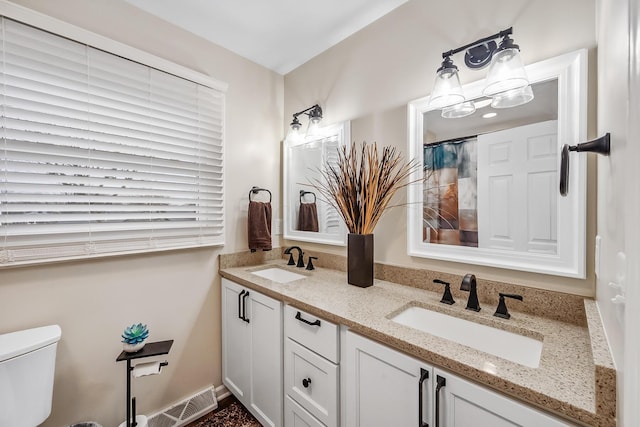 bathroom featuring vanity and toilet