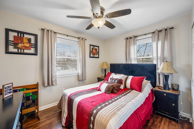 bedroom featuring multiple windows, dark hardwood / wood-style floors, and ceiling fan