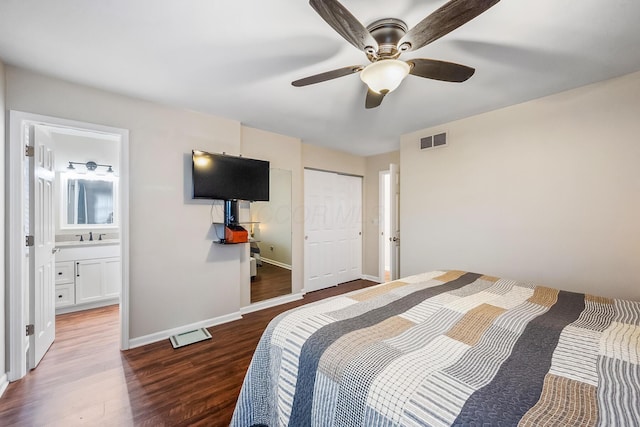 bedroom with ceiling fan, dark hardwood / wood-style floors, and sink