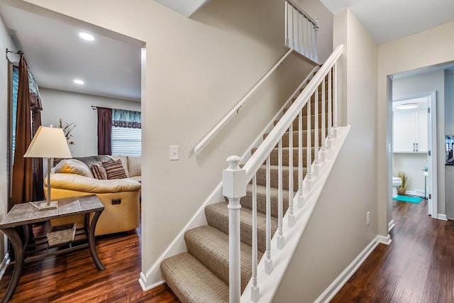 stairs featuring hardwood / wood-style floors