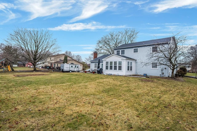 rear view of house with a lawn