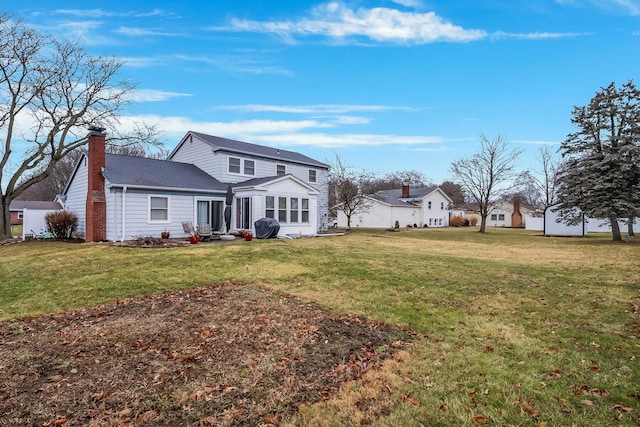 back of property featuring a lawn