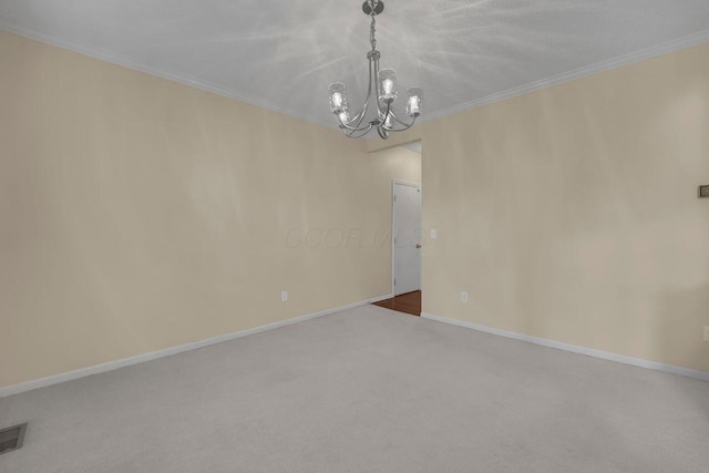 carpeted empty room with an inviting chandelier and crown molding