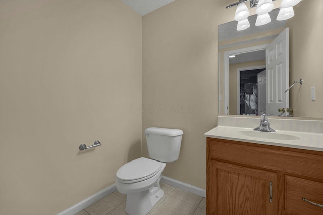 bathroom with vanity, tile patterned floors, and toilet